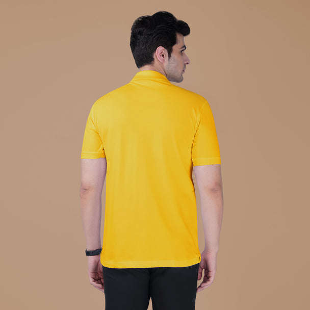 Back view of a man wearing the yellow Parambhakt Ganeshji Polo against a neutral studio background.