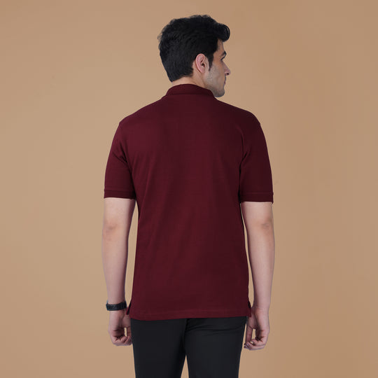 Back view of the maroon Parambhakt Om Polo T-shirt worn by a model against a neutral studio background.