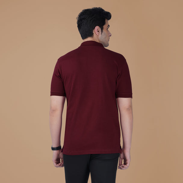 Back view of the maroon Parambhakt Om Polo T-shirt worn by a model against a neutral studio background.