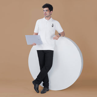 Man wearing the white Parambhakt Shivji Trishul Polo while holding a laptop, showcasing a modern spiritual lifestyle look.