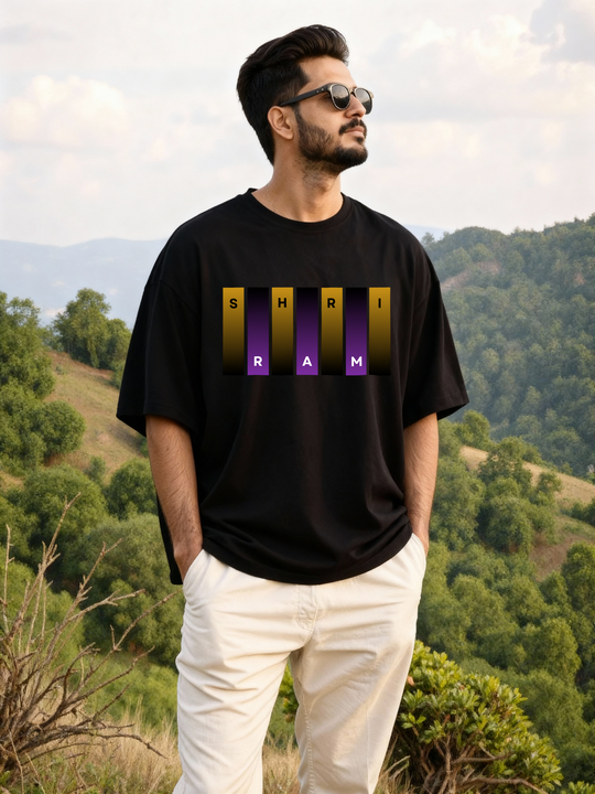 Man in a scenic mountain landscape wearing Parambhakt Shri Ram oversized T-shirt with sunglasses.
